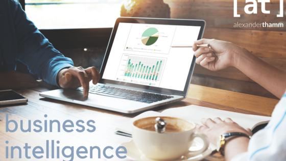 Business Intelligence Darstellung mit Laptop in einem Café - im Vordergrund eine Kaffeetasse und im Zentrum ein Datenvisualiserungsanwendung auf dem Laptopmonitor - das Logo der Alexander Thamm GmbH in der oberen rechten Ecke